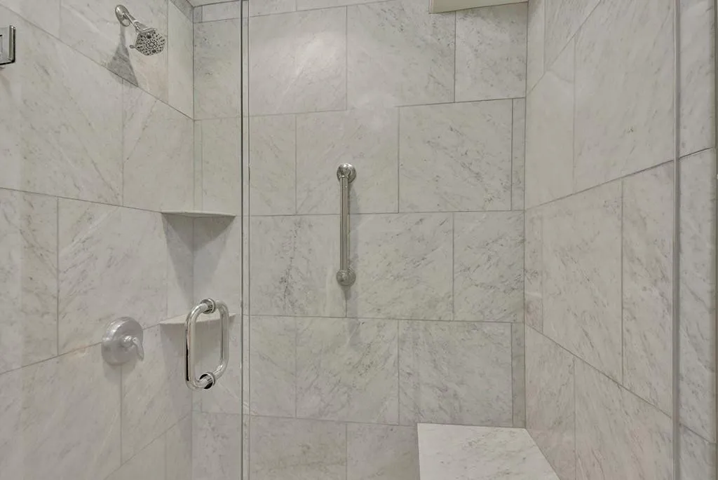 Room details with a shower with shower door