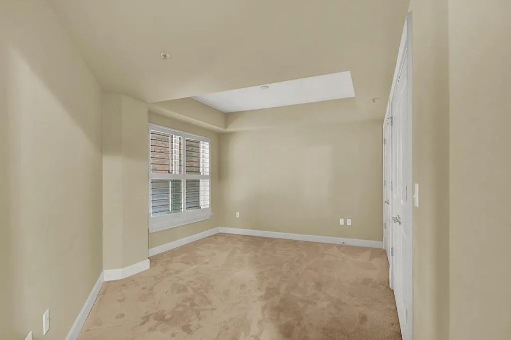Empty room featuring light carpet