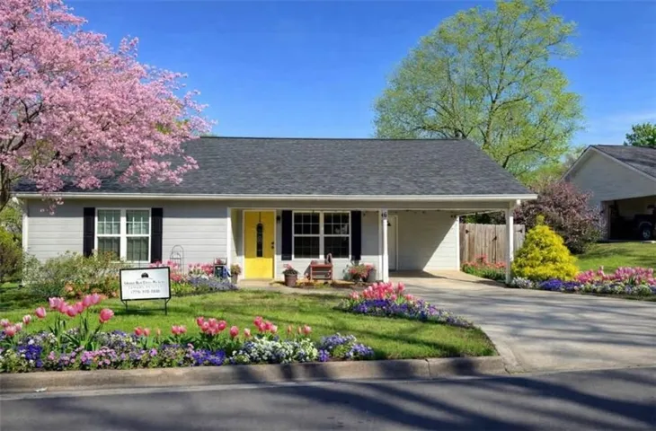 Light gray siding exterior with a dark gray shingle roof