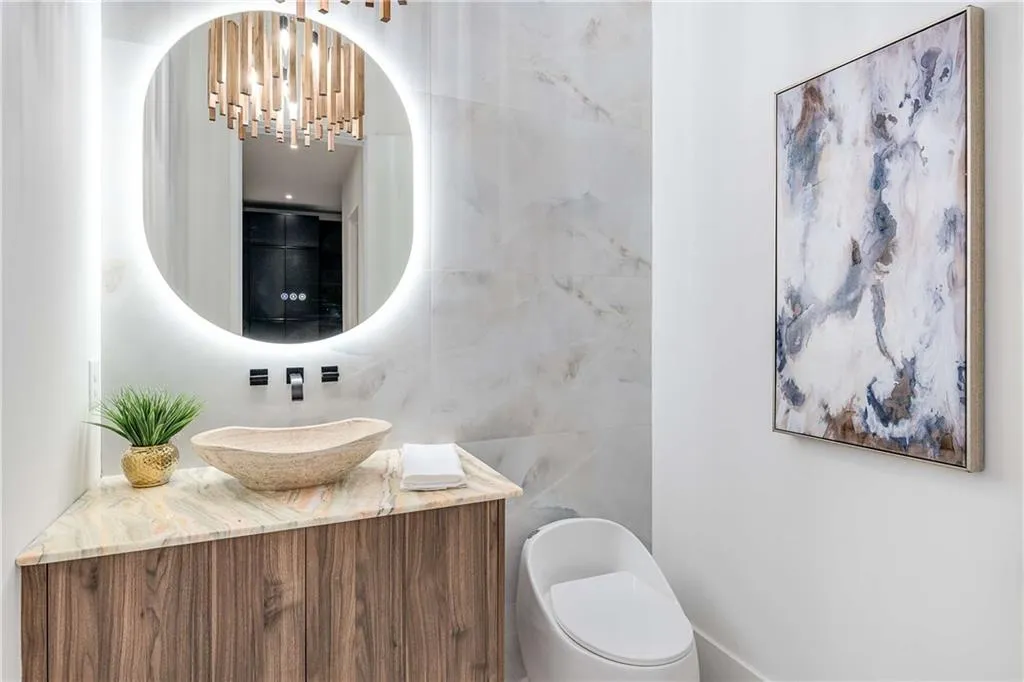 Half bathroom with vanity and tile walls