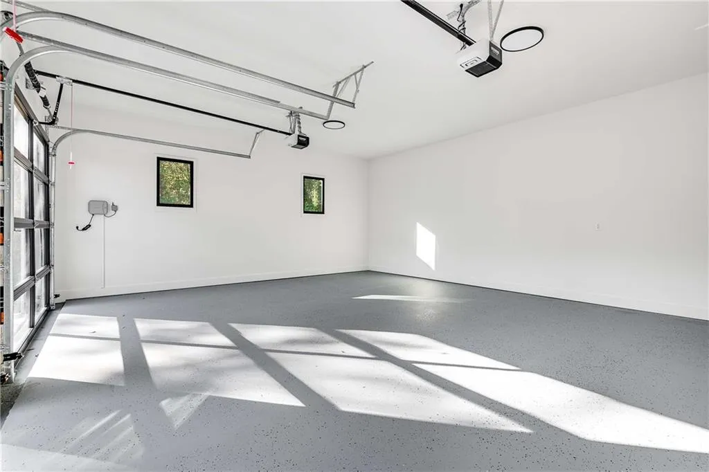 Garage with a garage door opener and baseboards
