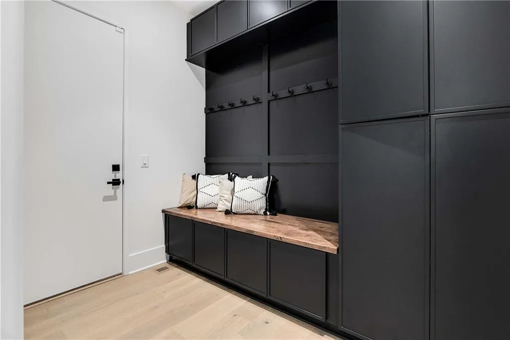 Mudroom featuring light wood finished floors and baseboards