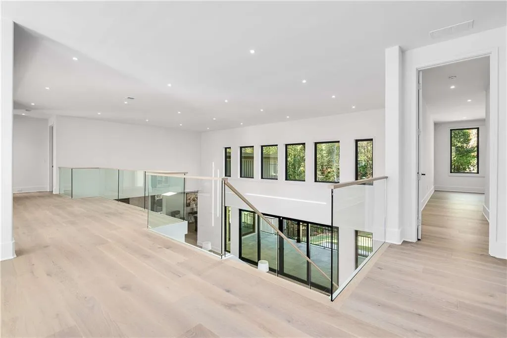 Corridor featuring an upstairs landing, recessed lighting, and light wood-style floors