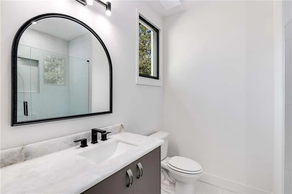 Full bath featuring a shower stall, vanity, and tile patterned floors