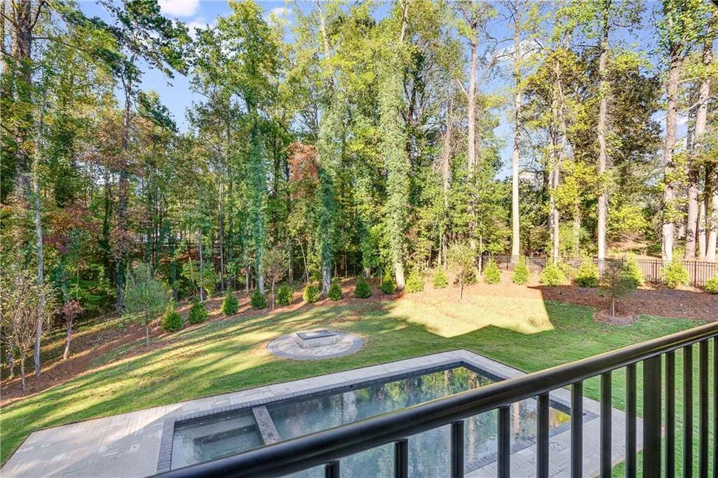 Fenced yard with a balcony