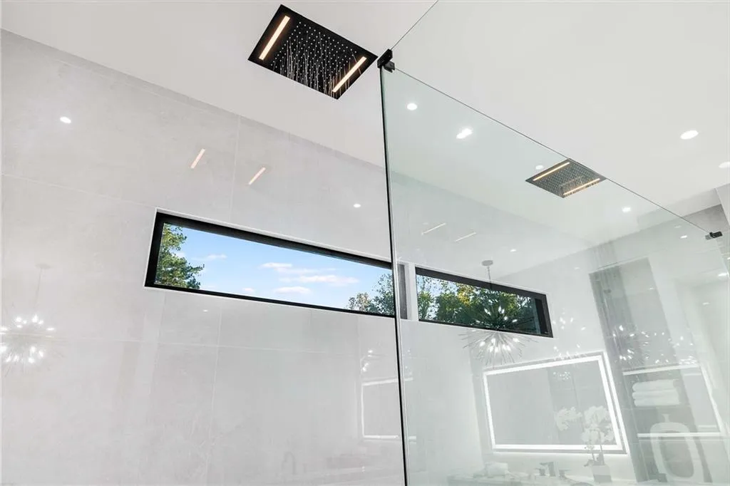 Bathroom view of hanging lights and tiled shower