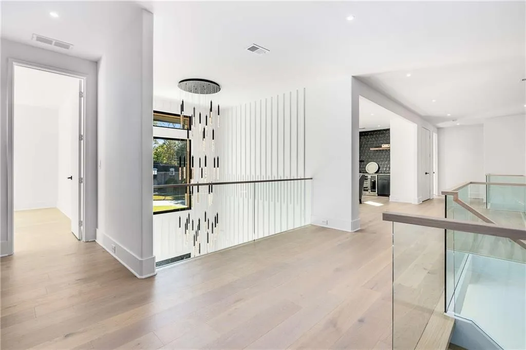 Hall featuring recessed lighting, light wood-style floors, and an upstairs landing