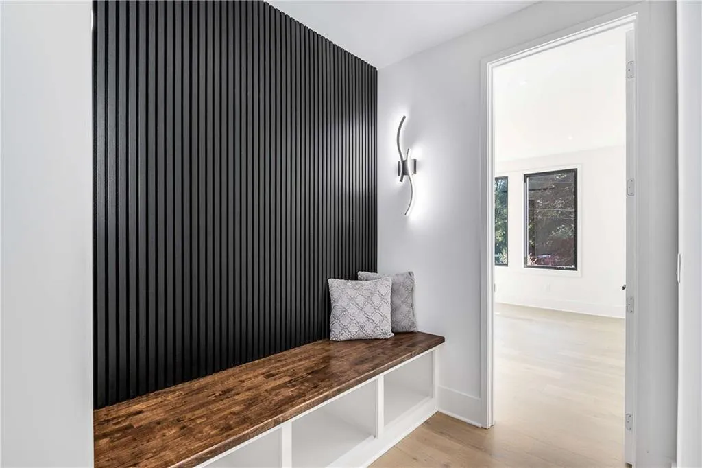 Mudroom with light wood-style flooring and an accent wall