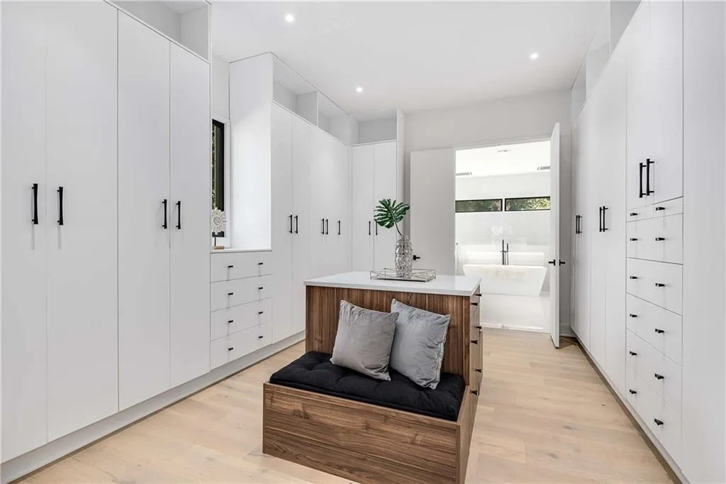 Walk in closet with light wood-style floors
