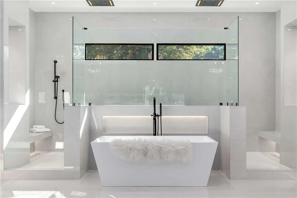 Full bath with walk in shower, a freestanding bath, and tile patterned flooring