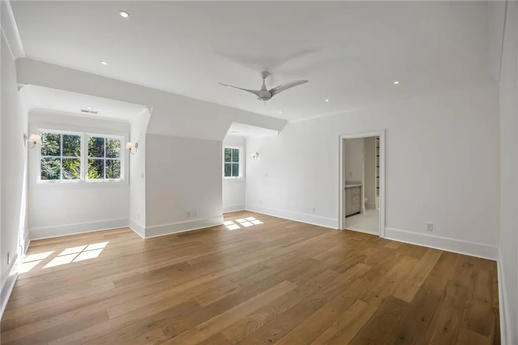 Interior space featuring wood-finish flooring, recessed lighting, multi-pane windows, and a ceiling fan