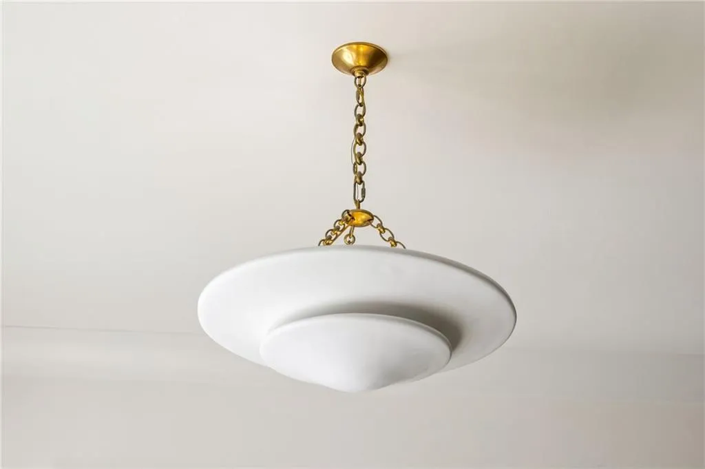 Tiered white glass pendant light featuring a metallic chain suspension and matching canopy