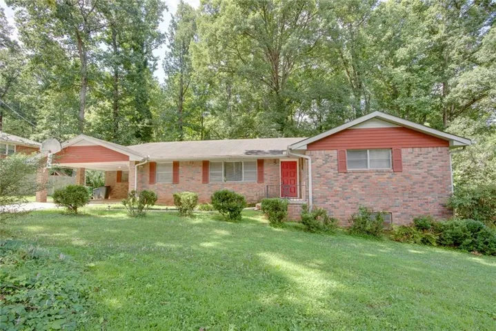 Brick exterior with red shutters and a matching red front door