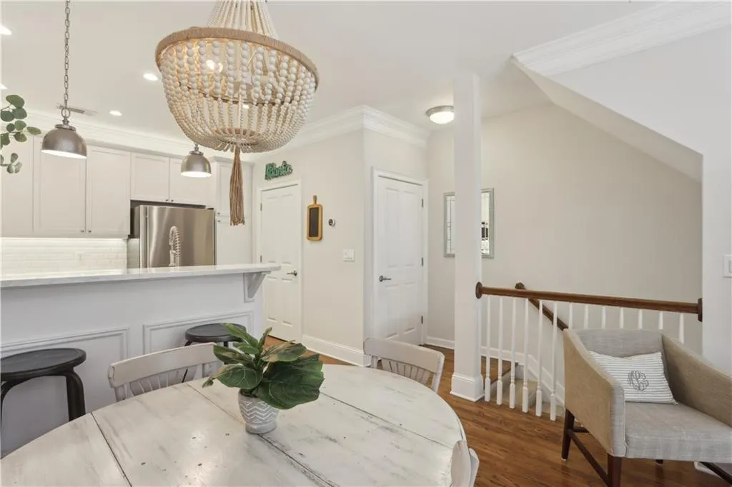 Dining area featuring dark wood-style floors, a chandelier, recessed lighting, and crown molding