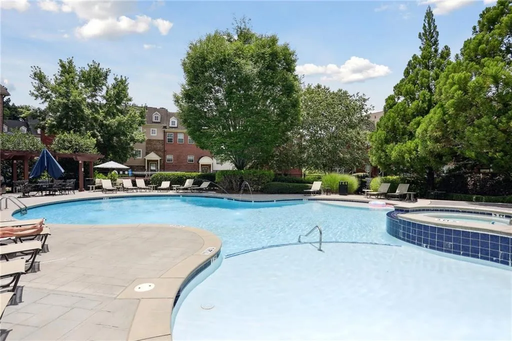 Community pool with waterfall hot tub and beach walk-in feature