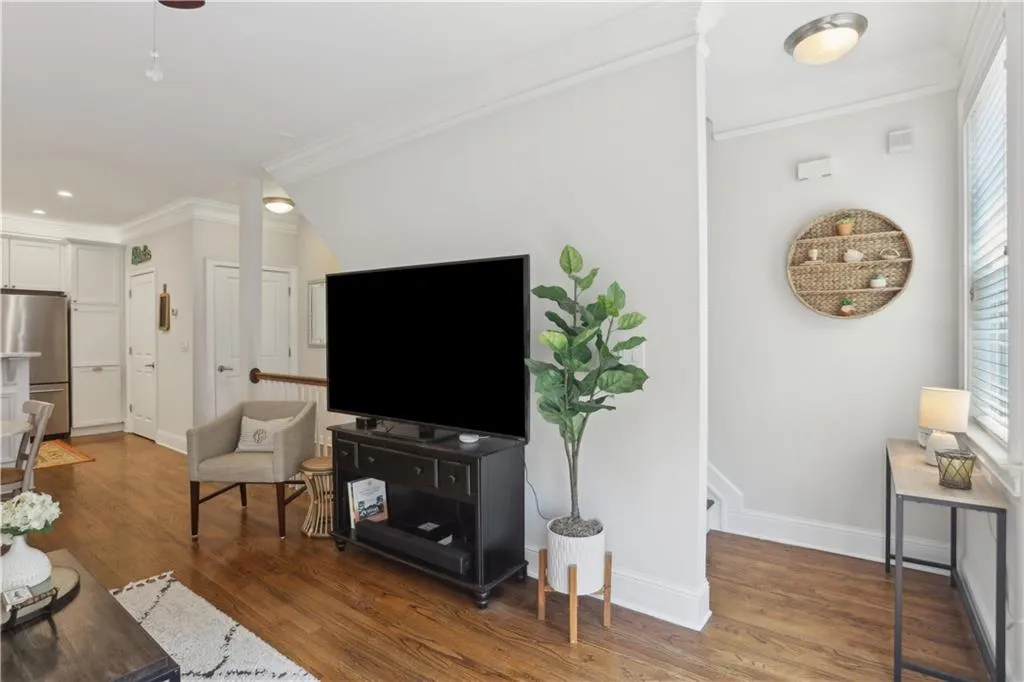 Living area featuring ornamental molding, wood finished floors, and recessed lighting