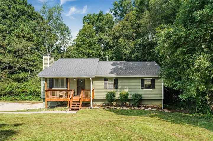 Siding exterior with a covered porch and wood decking