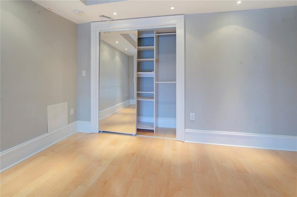 Unfurnished bedroom featuring a closet and light hardwood / wood-style floors