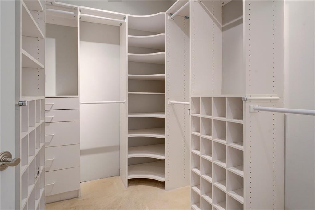 Walk in closet featuring light carpet