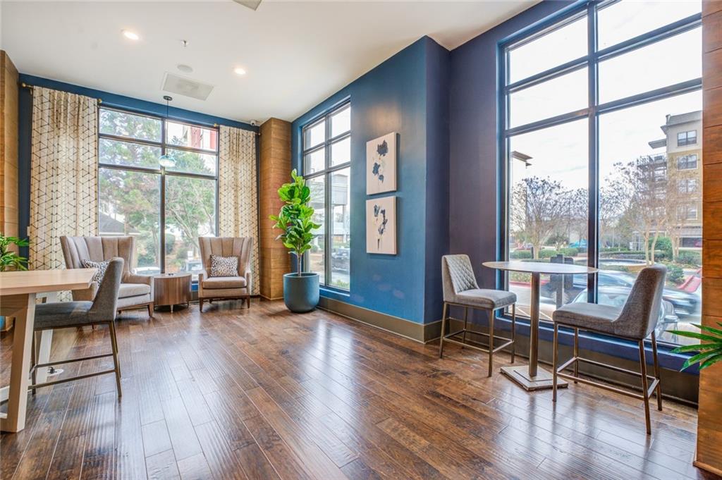 Sitting room featuring floor to ceiling windows and dark wood-type flooring