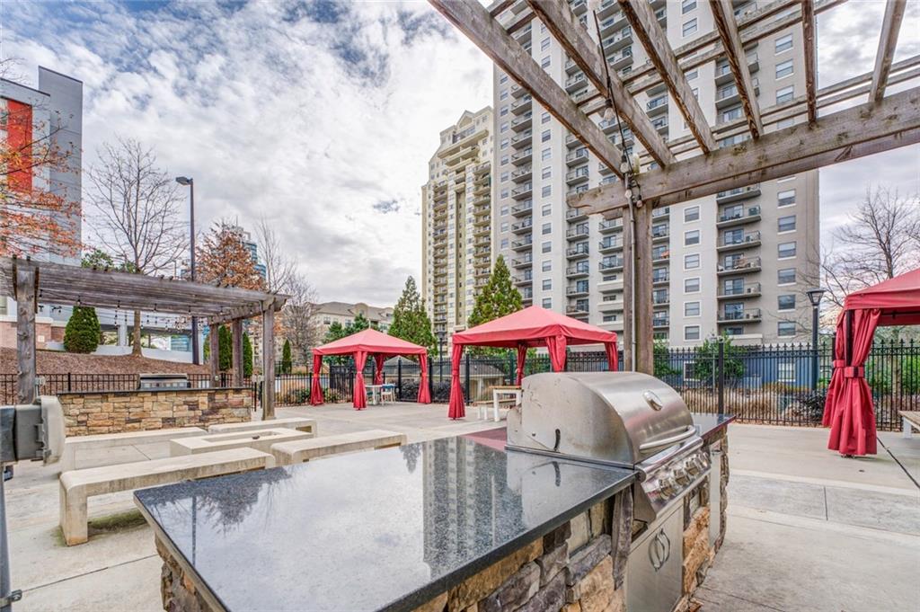 View of terrace with area for grilling, a gazebo, a pergola, and exterior kitchen