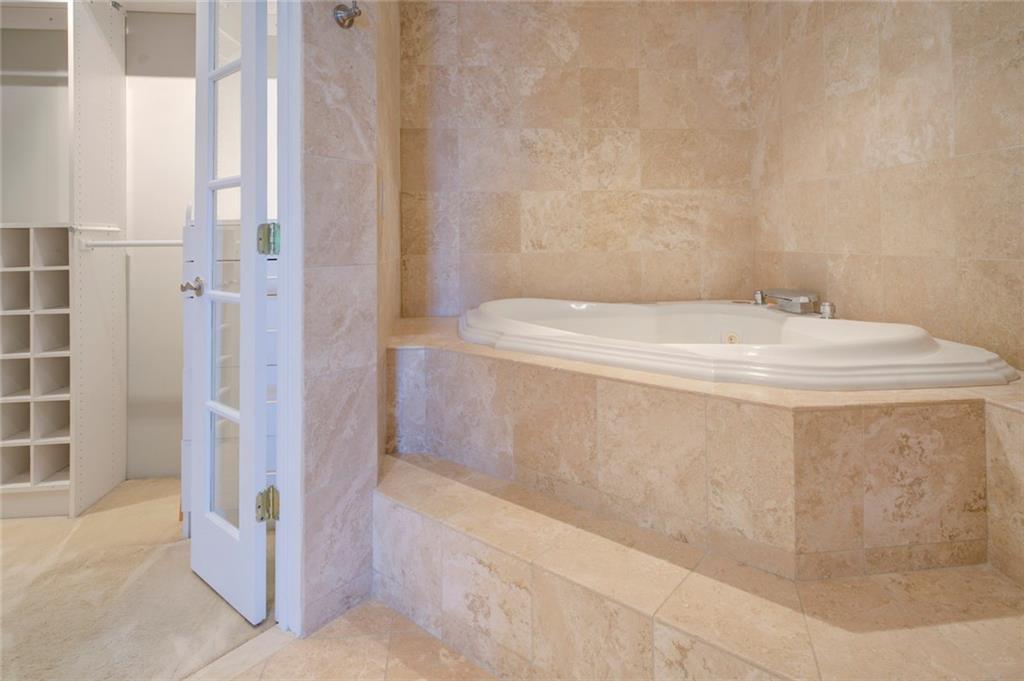 Bathroom with tile floors and a relaxing tiled bath