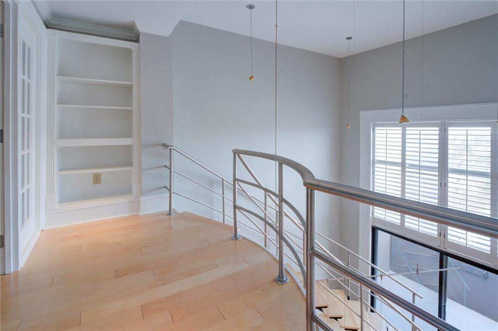 Hallway with built in features and light hardwood / wood-style floors