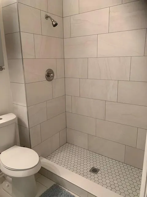 Bathroom featuring toilet and tiled shower