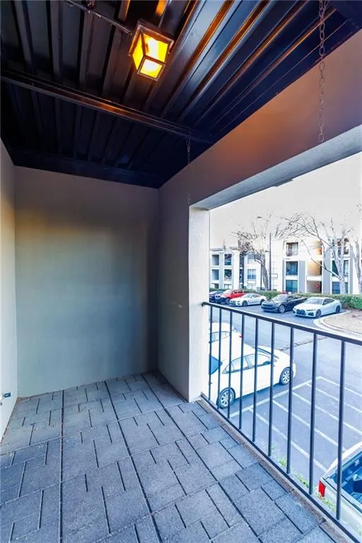 View of patio featuring a balcony