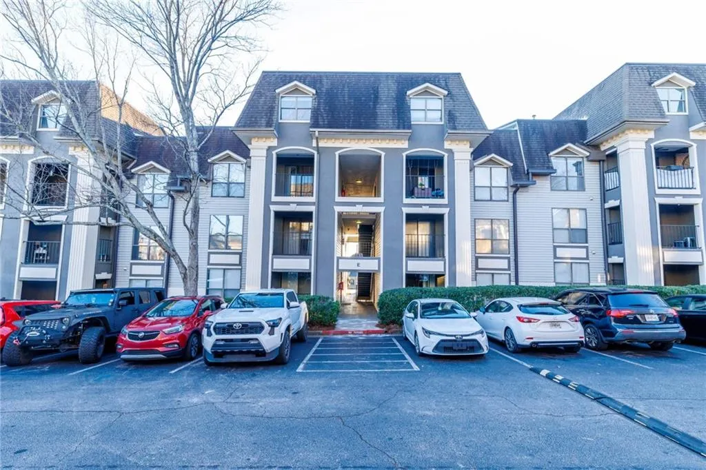 View of property featuring uncovered parking