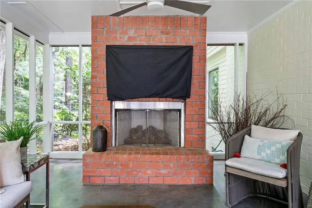 Screened Porch features an outdoor brick fireplace