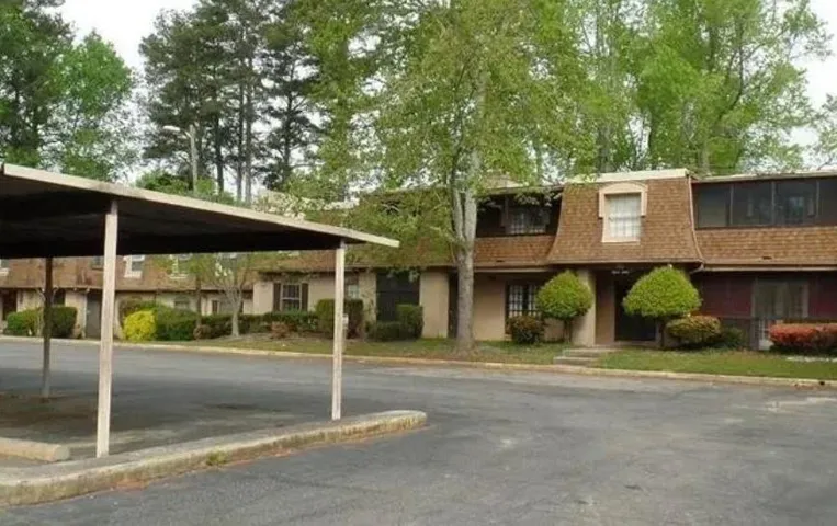 Carport structure, dormer window, and mature trees