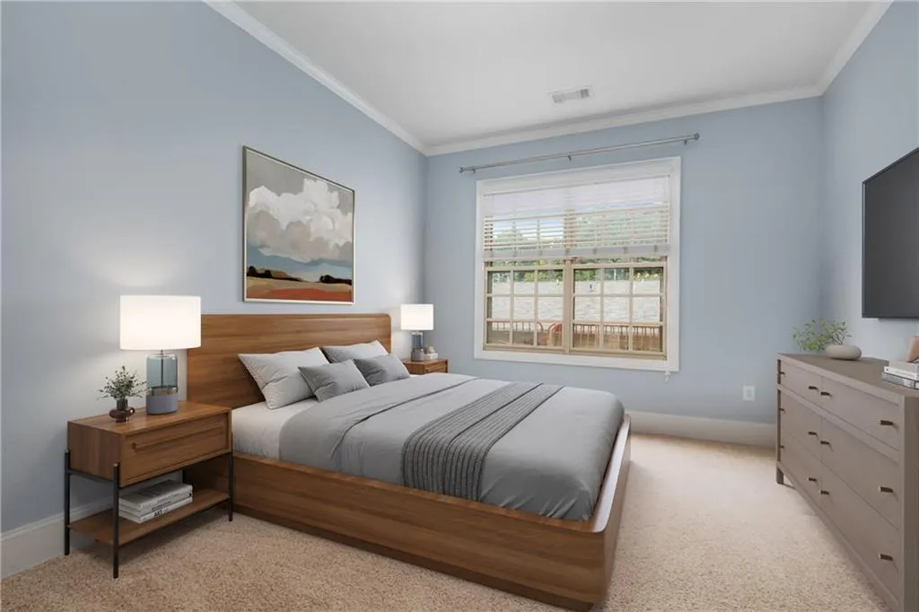 Bedroom featuring crown molding and light colored carpet