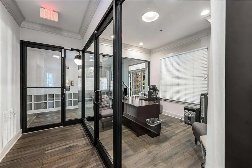 Office area with ornamental molding and dark wood finished floors