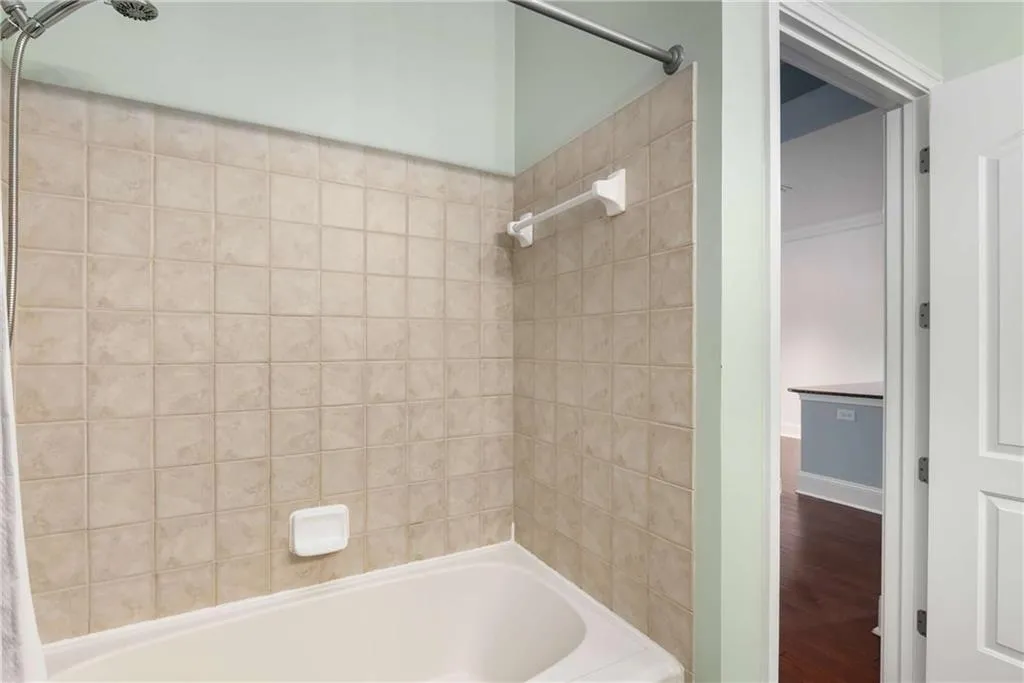 Bathroom with  shower combination and wood finished floors