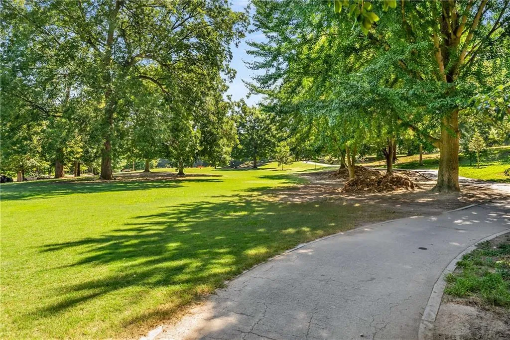 View of community with a yard and view of wooded area