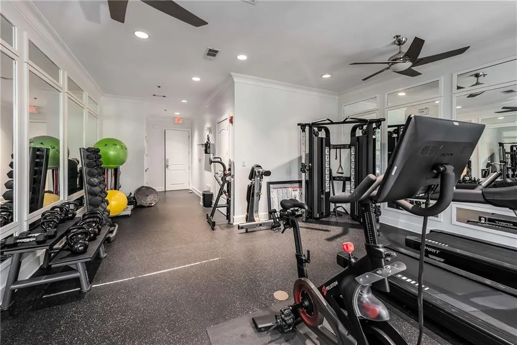 Workout area with a ceiling fan, ornamental molding, and recessed lighting