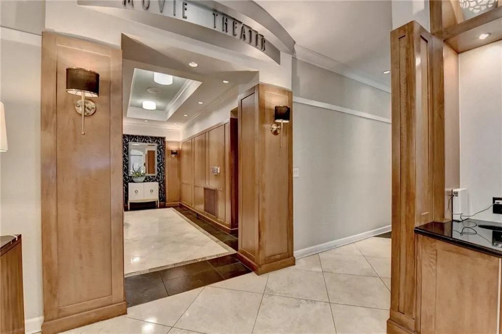 Hall featuring light tile patterned floors, crown molding, a tray ceiling, and recessed lighting