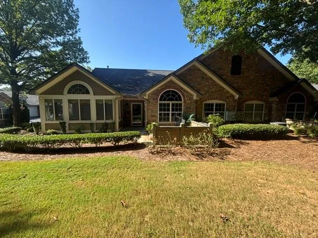 Brick and siding exterior with arched transom windows