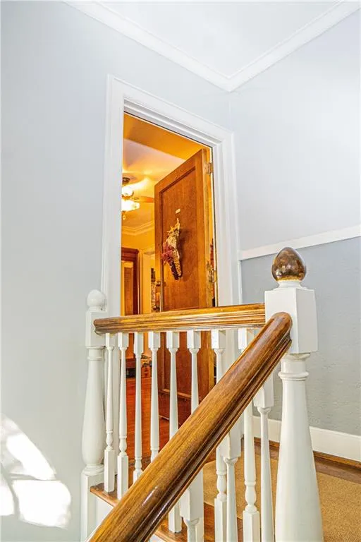 Staircase featuring crown molding