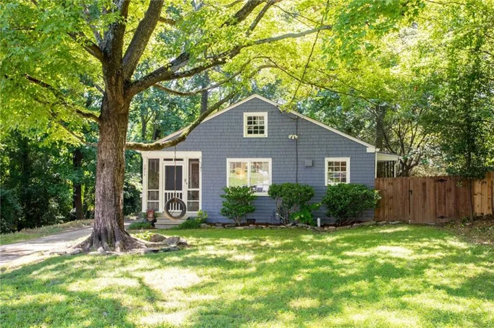 Front exterior with blue shingle siding, white trim windows, and a screened-in porch