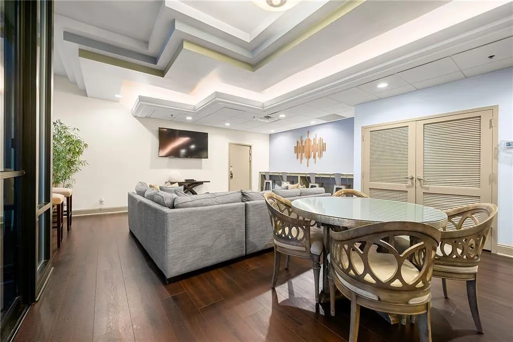 Dining room featuring dark wood-style flooring and baseboards
