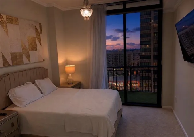 Floor-to-ceiling glass doors open to a balcony with black railings
