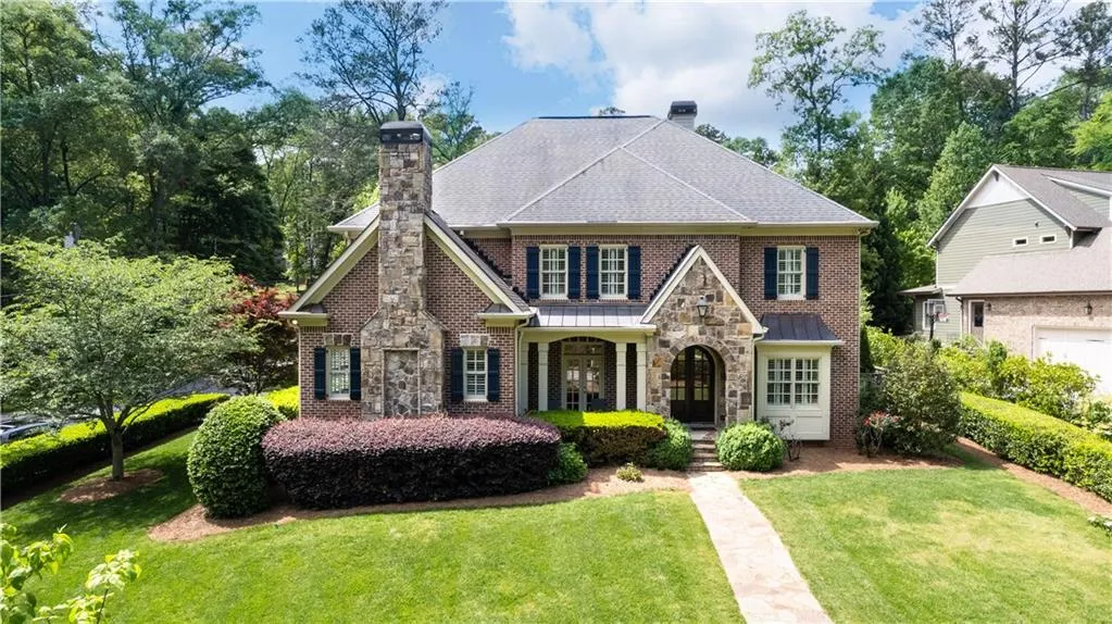 View of front of house with a garage and a front lawn