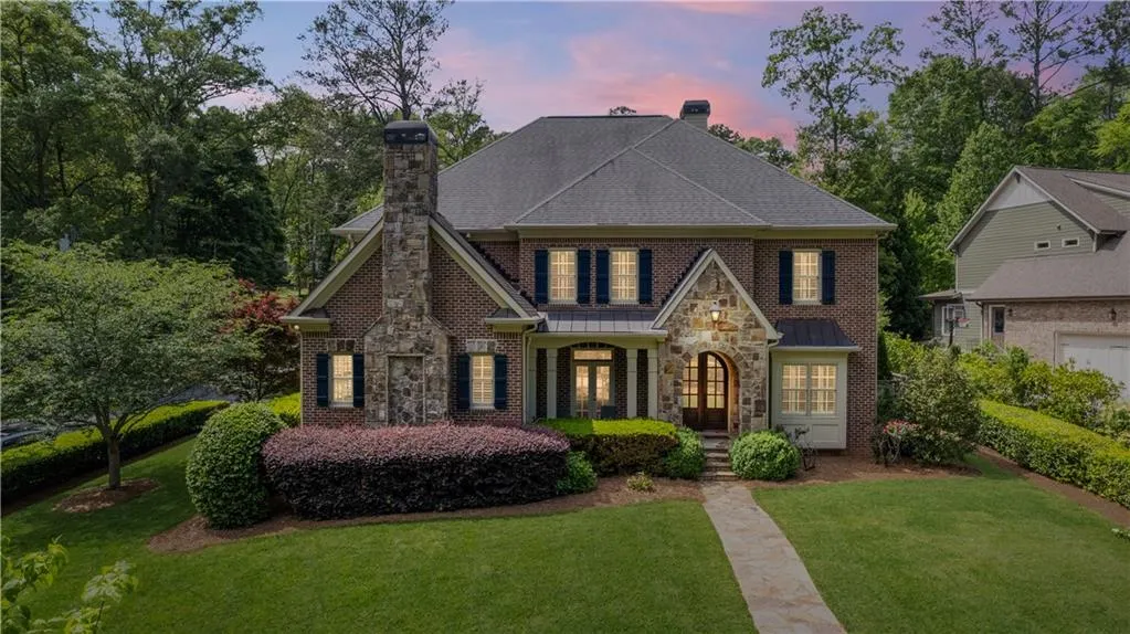 View of front of house featuring a garage and a lawn