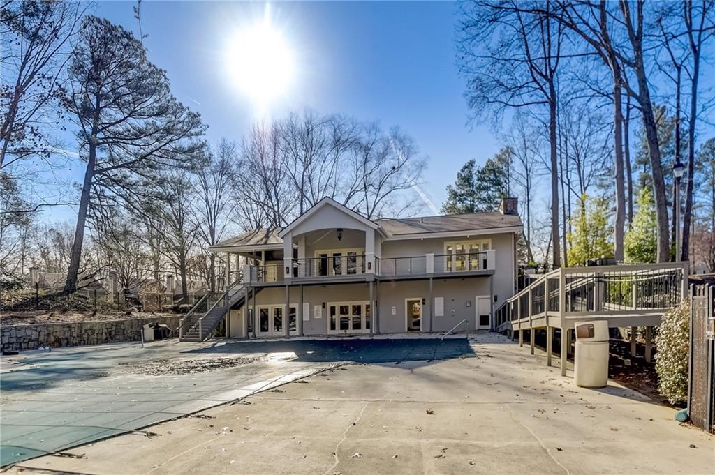 View of property with a balcony and a patio