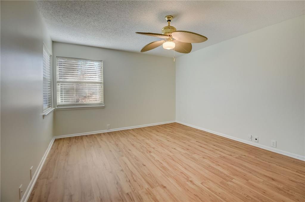 Unfurnished room with light hardwood / wood-style floors, a textured ceiling, and ceiling fan