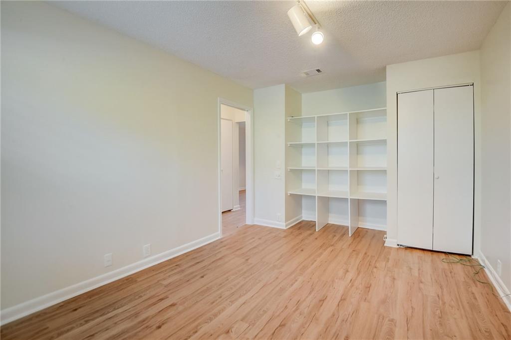 Unfurnished bedroom featuring light hardwood / wood-style floors and a textured ceiling