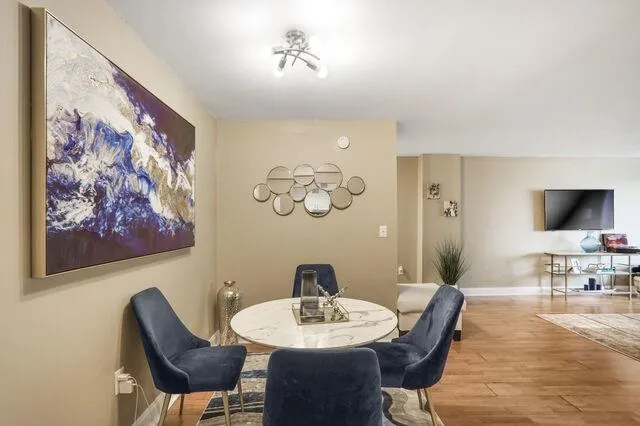 Dining space featuring wood finished floors and baseboards