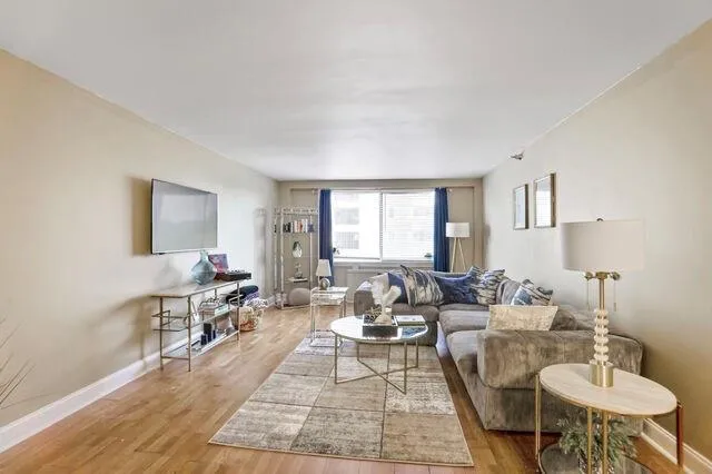 Living room with baseboards and light wood finished floors